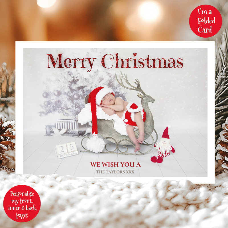 a christmas card with a baby in a sleigh