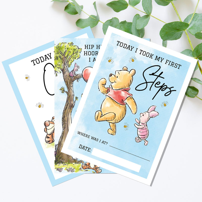 two winnie the pooh birthday cards on a table