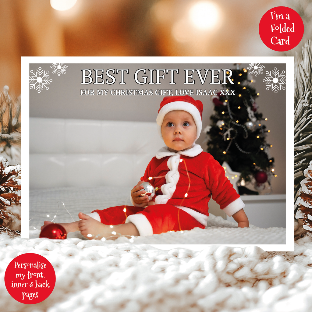 a christmas card with a baby in a santa suit