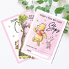 two winnie the pooh birthday cards on a table